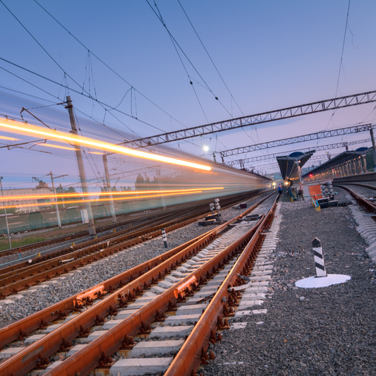 Rail tracks and blurred lights.